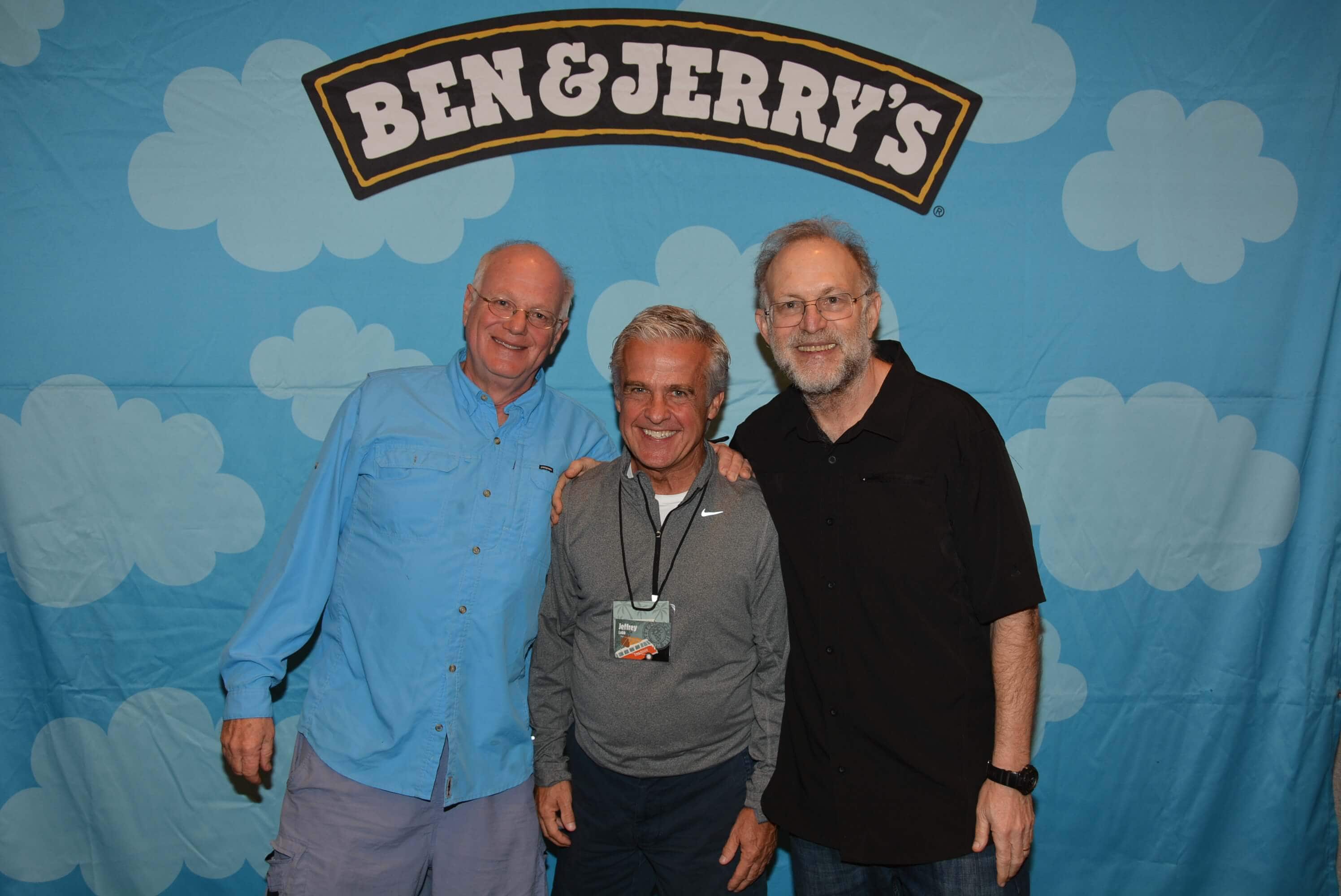 Group of guys in front of a large fabric print with the Ben & Jerry's lettering
